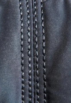 Cloth stitched with threads close-up. Stock Photos