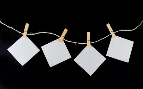 Clothe pin on the rope with paper note on the black background Stock Photos