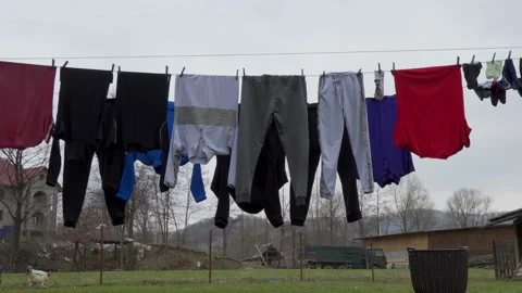 Clothes after washing, drying on a line, in the backyard of the house. Stock Footage 180682311