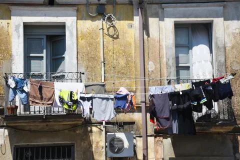 Clothes air drying on a second floor balcony Stock Photos