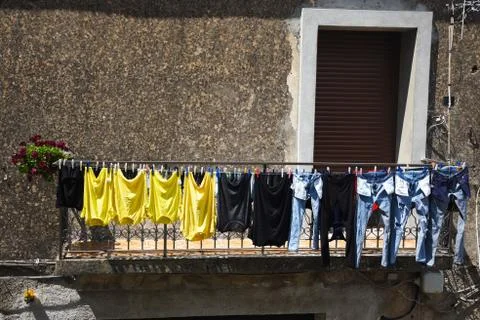 Clothes air drying on a second floor balcony Stock Photos