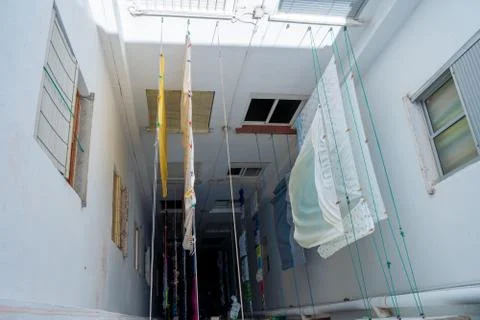 Clothes and sheets on clotheslines. Common area of the building Stock Photos