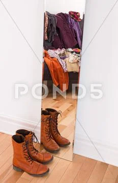 Clothes and shoes reflecting in the mirror Stock Photos