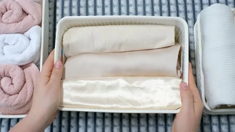 Clothes and towels in plastic containers top view, space organization concept. Stock Footage 168682308