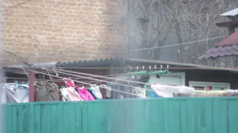 Clothes are dried in the yard swinging at wind Stock Footage 113449990