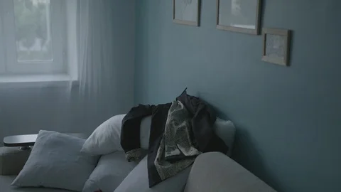 Clothes are flying on the sofa Video stock 100540997