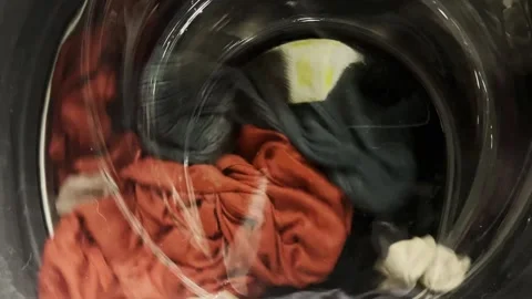 Clothes are washed in a washing machine. The process of washing things in a Stock Footage 274654653