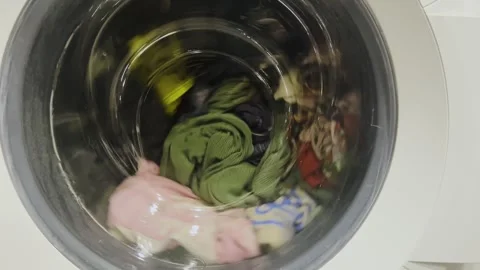 Clothes are washed in a washing machine. The process of washing things in a Stock Footage 275242443