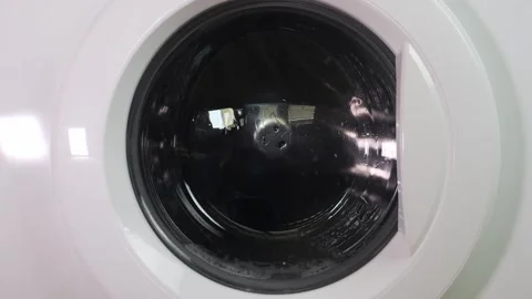 Clothes are washed in a washing machine, the drum with water and detergent is Stock Footage 315726985