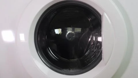 Clothes are washed in a washing machine, the drum with water and detergent .. Stock Footage 332164688