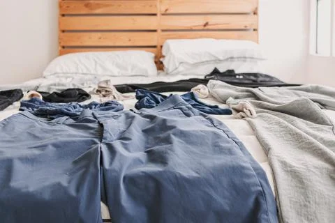 Clothes on the bed. Concept of housework and clean up clothes. Stock-Fotos