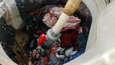 Clothes Being Washed Inside a Laundry Machine During the Washing Process Stock Footage 305167046