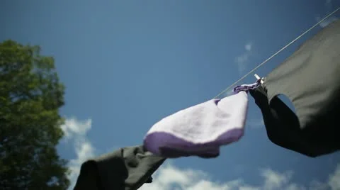 Clothes Blowing on Clothesline Under Blue Sky Stock Footage 21458959