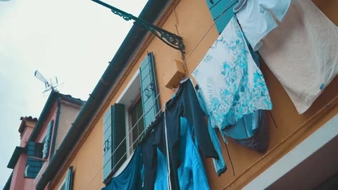 Clothes on clothesline outside. laundry drying outdoor at old italian street Stock Footage 196091194