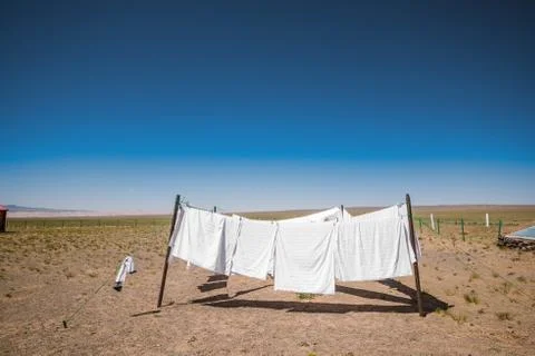 Clothes on clotheslines in field Stock Photos