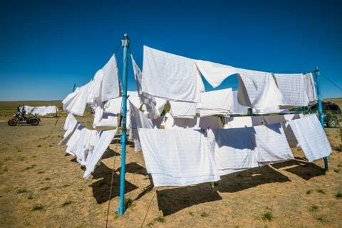 Clothes on clotheslines in field Stock Photos