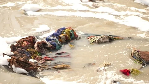 Clothes collected in the middle of river, Waste collected in river Stock Footage 148197999