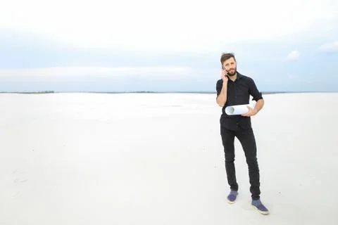 Clothes designer using smartphone to communicate with brother Foto stock