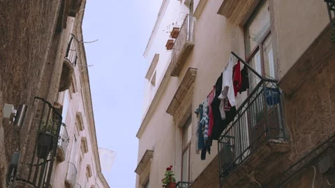 Clothes drying on balconies along the streets of Italy Stock Footage 277347447