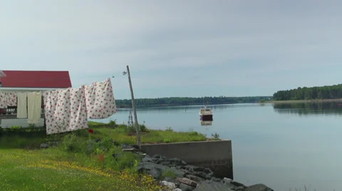 Clothes Drying by the Calm Morning Waters Near a Fishing Boat Stock Footage 37064200