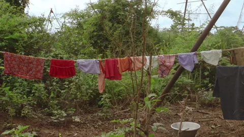 Clothes drying on a clothesline in rural Myanmar Video stock 332765656