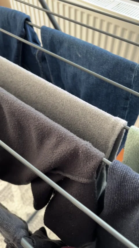 Clothes Drying on Indoor Laundry Rack With Fabric Textures and Casual Househo Stock Footage 334673094