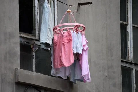Clothes drying outside an old apartment window Stock Photos