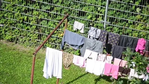 Clothes drying outside in the sunshine Stock Footage 281107838