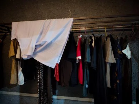 Clothes drying room with some clothes being dried Stock Photos