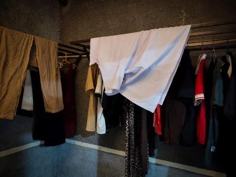 Clothes drying room with some clothes being dried Stock Photos