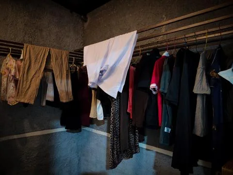 Clothes drying room with some clothes being dried Stock Photos