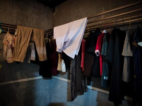 Clothes drying room with some clothes being dried Stock Photos
