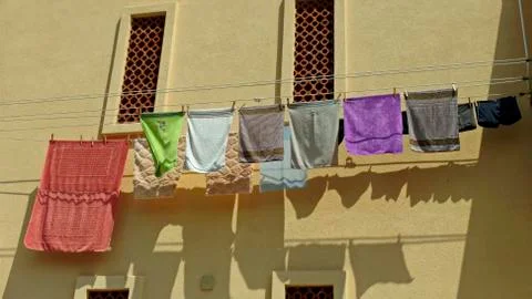 Clothes drying on the rope. Under the Windows drying clothes. Stock Photos