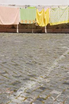 Clothes drying at the sidewalk  Stock Photos