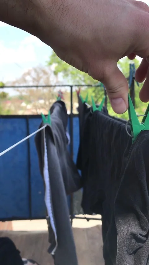 Clothes drying in the sun on a clothesline in warm weather Stock Footage 308368330