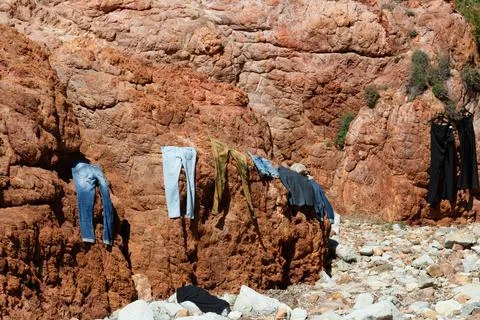 Clothes drying in the sun on a rock Stock Photos