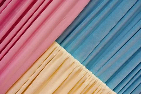 Clothes fabrics samples hang in light hallway at exhibition Stock Photos