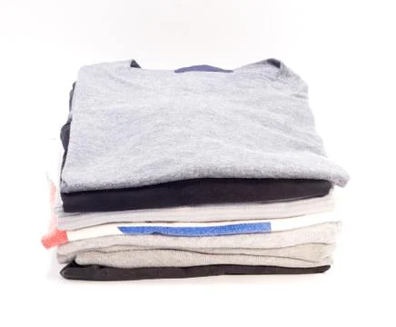 Clothes folded on a white background. Stock Photos