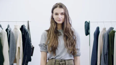 Clothes get thrown at woman's face in a dressing room Stock-Footage 103825769