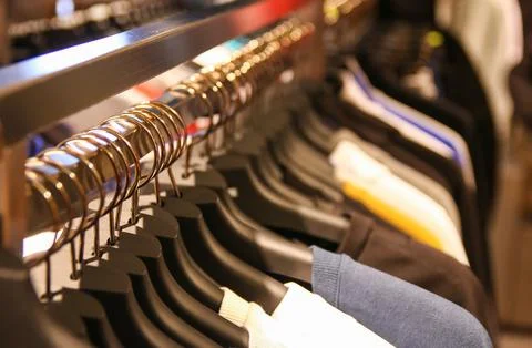 Clothes hang on a shelf Stockfoto's