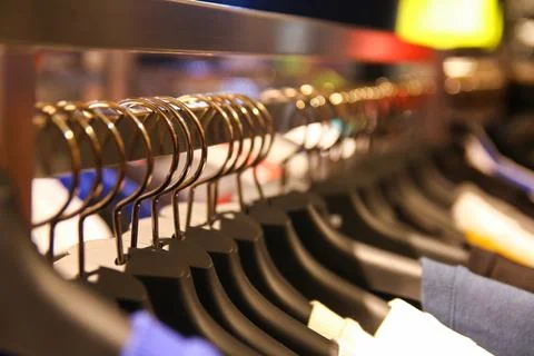 Clothes hang on a shelf 库存照片