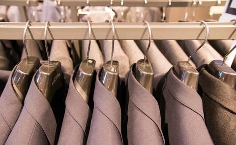 Clothes hang on a shelf 库存照片