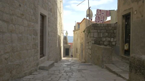 Clothes hanged on wire to dry seen on a narrow street, Dubrovnik Stock Footage 60388161