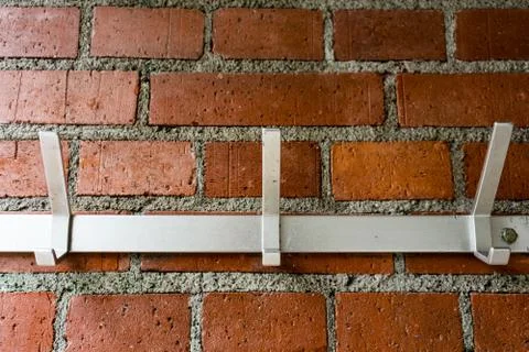 Clothes hanger on brick wall Stock Illustration