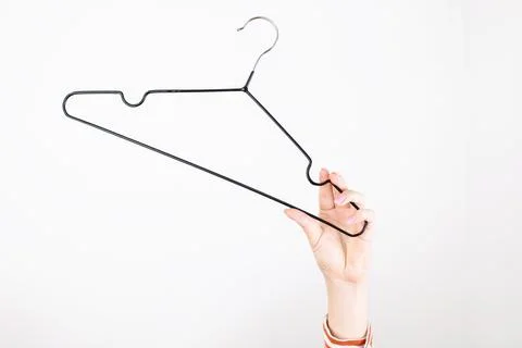 Clothes hanger close-up in hand Stock-Fotos