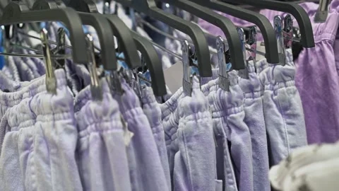 Clothes hanger with a variety of things slow motion, soft selective focus, store Video stock 194093863