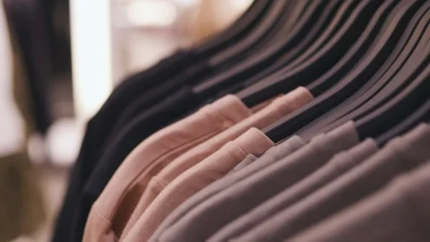 Clothes on hangers in a store. Camera movement. Close up. Stock Footage 267719727