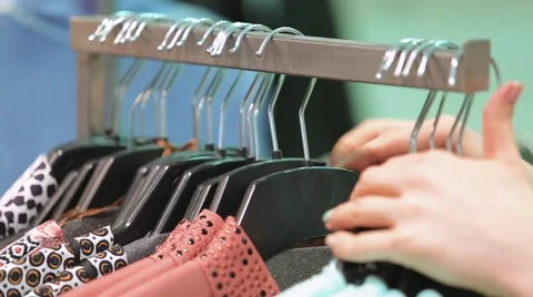 With clothes hangers in the store Video stock 61070838