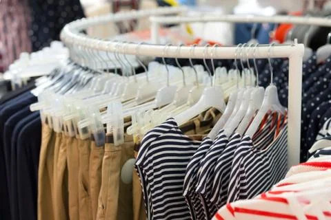 Clothes on hangers in store Foto stock