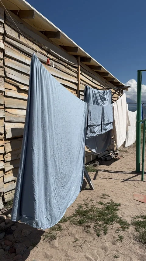 Clothes hanging and drying on a clothesline outdoors, 4K vertical Stock Footage 342028553
